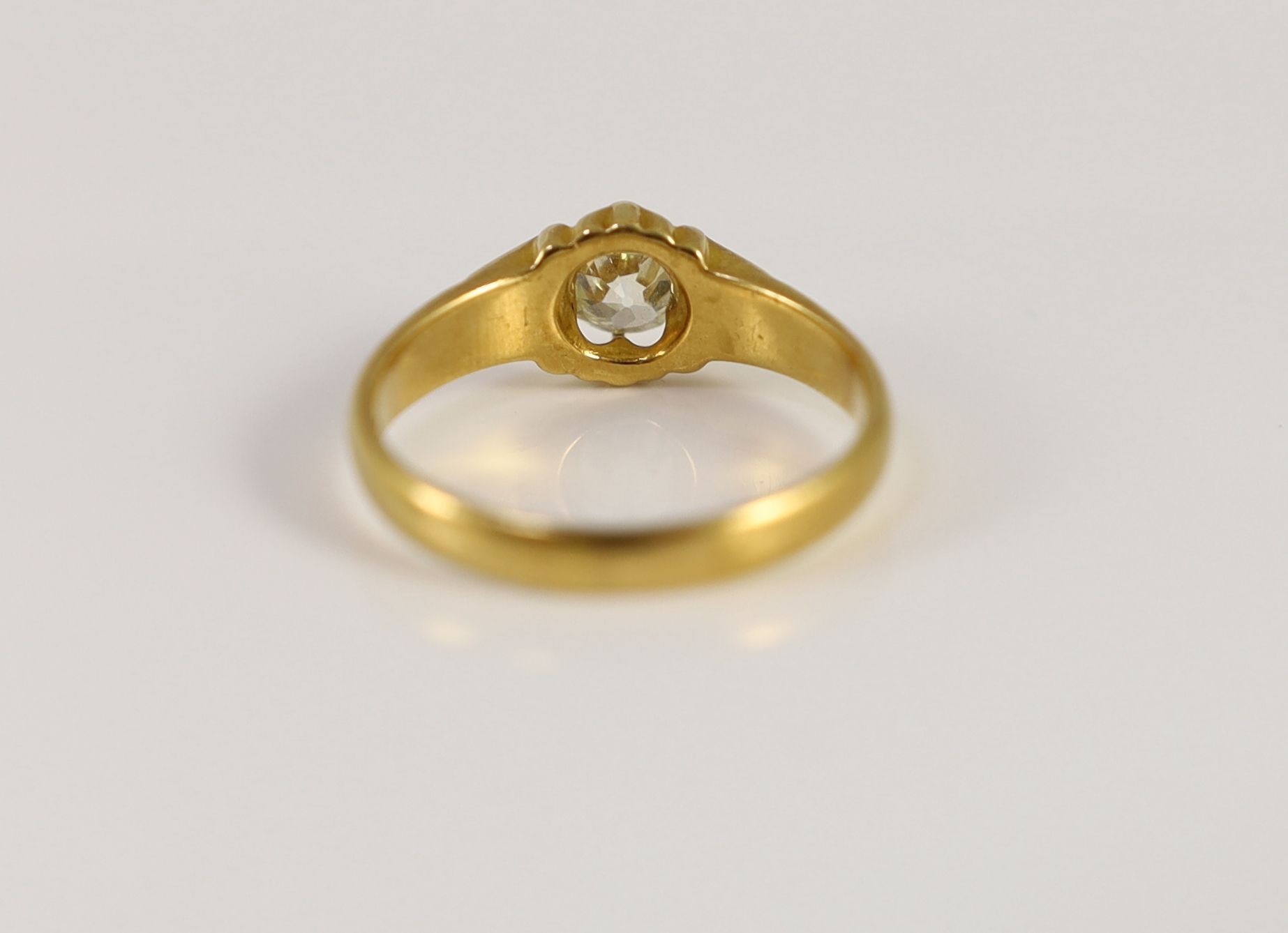 A late Victorian 18ct gold and claw set oval cushion cut diamond set ring